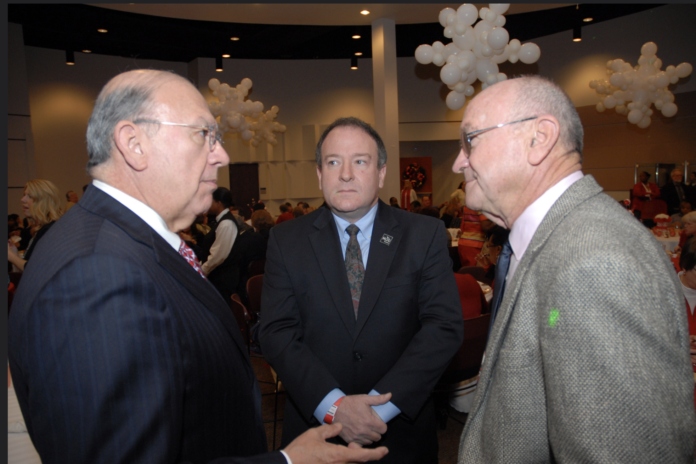 Trustees Robert Glaser (center) and Dave Wilson (right) speak with Chancellor Cesar Maldonado at a college event